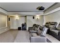 Cozy home theater with tiered seating, projector, and wall sconces at 7940 Royal Melbourne Way, Duluth, GA 30097