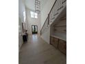 Grand foyer with high ceilings, staircase with iron railing, and stylish console table at 315 Hillcrest View Dr, Suwanee, GA 30024