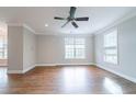 Spacious living room with hardwood floors, large windows, and neutral walls, creating a welcoming atmosphere at 4915 Wycliffe Dr, Stone Mountain, GA 30087