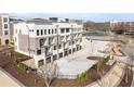 Rear exterior shot with garages and outside parking spots for this new complex at 7210 Summit Pl, Alpharetta, GA 30009