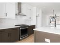 Modern kitchen featuring stainless steel appliances, white cabinets, and sleek countertops at 7210 Summit Pl, Alpharetta, GA 30009