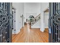 Grand foyer with hardwood floors, soaring ceilings, and an elegant staircase at 1450 Chadberry Way, Lawrenceville, GA 30043