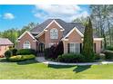 Stunning brick home boasts manicured lawn, walkway, and well-maintained landscaping at 1450 Chadberry Way, Lawrenceville, GA 30043
