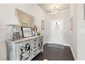 Beautiful foyer with shiplap accent wall, elegant lighting, and stylish console table at 207 Magnolia Creek Way, Woodstock, GA 30188