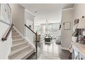 Inviting living room with staircase, hardwood floors, and a view of the cozy living space at 207 Magnolia Creek Way, Woodstock, GA 30188