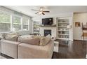 Comfortable living room featuring a fireplace, built-in shelving, and abundant natural light at 207 Magnolia Creek Way, Woodstock, GA 30188