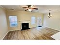 Bright living room featuring a fireplace, hardwood floors, and windows overlooking the backyard at 4134 Rogers Creek Ct # 41, Duluth, GA 30096