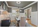 Elegant dining room with wainscoting, stylish chandelier, and ample natural light at 55 Hazelbrook Way, Acworth, GA 30101