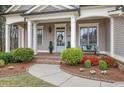 Welcoming front porch with lush landscaping, a seating area and decorative details at 55 Hazelbrook Way, Acworth, GA 30101
