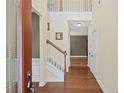 Light-filled foyer with hardwood floors, white staircase, and neutral paint, offering a welcoming entrance at 453 Clematis Ct, Temple, GA 30179