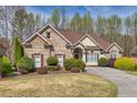 Charming single-Gathering home with brick facade and manicured landscaping at 2323 Council Ln, Buford, GA 30519