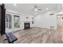 Spacious living area featuring a fireplace, ceiling fan, hardwood floors, and glass doors to the outside at 554 Mcgill Ne Pl, Atlanta, GA 30312