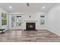 Bright living room with hardwood floors, fireplace, ceiling fan, and a sliding glass door to the outside at 554 Mcgill Ne Pl, Atlanta, GA 30312