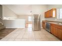 Open-concept kitchen with stainless steel appliances and tiled floors at 5175 Walker Rd, Stone Mountain, GA 30088