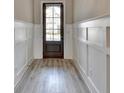 Elegant foyer with paneled walls and hardwood floors, leading into the home at 6585 Creekview Cir, Duluth, GA 30097