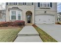 Beautiful home with a brick facade, arched entryway, and manicured landscaping for a welcoming curb appeal at 6585 Creekview Cir, Duluth, GA 30097