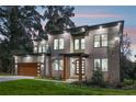 Modern home with a balcony, stone accents, and well-manicured front yard, perfect for families at 1604 Niskey Lake Sw Rd, Atlanta, GA 30331