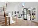 Bright foyer with soaring ceilings, showcasing a staircase and view to the living room with oversized windows at 1610 Niskey Lake Sw Rd, Atlanta, GA 30331