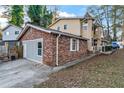 View of the exterior of the home, with a brick facade and attached garage at 3189 Bellgreen Way, Decatur, GA 30032