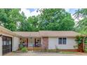 Inviting front of home with rocking chairs and a brick accent wall at 322 Kibbee Rd, Mcdonough, GA 30252