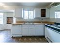 Practical kitchen layout with essential appliances, wood countertops and window views at 5255 Biffle Downs Rd, Stone Mountain, GA 30088