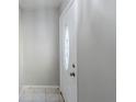 Entryway featuring a decorative front door with oval glass insert and neutral walls at 870 Chapman Cir, Stone Mountain, GA 30088