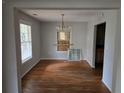 Bright dining room features hardwood floors, natural light, and a view into the kitchen for easy entertaining at 1142 Windsor Sw St, Atlanta, GA 30310