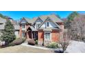 Beautiful brick home with gable roof, landscaping, and paved driveway at 2505 Weber Heights Way, Buford, GA 30519