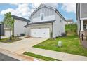 Attractive two-story home features an attached garage and verdant lawn at 2770 Aralynn Way, College Park, GA 30337