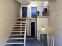 Stairway landing featuring dark painted doors, neutral paint and metal handrails at 315 Seasons Pkwy, Norcross, GA 30093