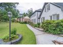 Well-maintained home exterior with lush green lawn and landscaped walkway at 3442 Inns Brook Way, Snellville, GA 30039
