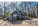Exterior view of the home showcasing the deck and wooded lot at 477 Victoria Rd, Woodstock, GA 30189