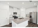 Stylish kitchen with white cabinets, stainless steel appliances, granite countertops and island at 360 White Tail Rd, Stockbridge, GA 30253