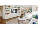 Bright living room features hardwood floors, white built-in shelving and cabinets and modern decor at 2506 Parkdale Ne Pl, Atlanta, GA 30305
