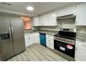 Modern kitchen with stainless steel appliances, white cabinets, and granite counters at 5806 Par Four Ct, Lithonia, GA 30038