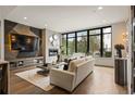 Stylish living room with a fireplace, large window, and contemporary design elements at 904 Lenox Ne Blvd, Atlanta, GA 30324