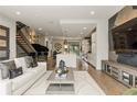 Bright living room showcasing an open floor plan, a modern staircase, and sleek decor at 904 Lenox Ne Blvd, Atlanta, GA 30324