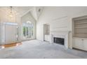 Bright living room featuring high ceilings, built-in shelves, and a marble fireplace at 1244 Newbridge Ne Trce, Atlanta, GA 30319