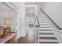 Elegant entryway with hardwood floors, staircase, and views into dining room at 1835 Berkeley Ne Mews, Atlanta, GA 30329