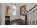 Elegant foyer with dark wood floors, a decorative art piece, and a view of the staircase at 340 Marietta Walk Ln, Marietta, GA 30064