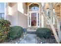 Close-up of a home's inviting entrance featuring a glass door and well-kept landscaping at 3270 River Summit Trl, Duluth, GA 30097