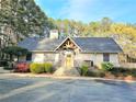 Community clubhouse featuring stone accents, dark roof, and lush landscaping at 35 Rumson Se Ct, Smyrna, GA 30080