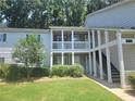 Charming condominium complex featuring covered porches, convenient stair access, and well-manicured landscaping at 35 Rumson Se Ct, Smyrna, GA 30080