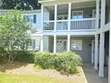 Condominium complex exterior with multiple units, covered porches, and a beautifully maintained landscaped yard at 35 Rumson Se Ct, Smyrna, GA 30080