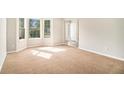 Bright empty room featuring a bay window that allows plenty of natural light at 498 Pecan Wood Cir, Fairburn, GA 30213