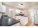 Modern kitchen featuring white cabinets, tile flooring, and stainless steel appliances at 498 Pecan Wood Cir, Fairburn, GA 30213