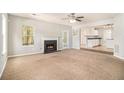 Cozy living room with a fireplace, neutral carpet, and plenty of space to relax and unwind at 498 Pecan Wood Cir, Fairburn, GA 30213