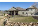 Landscaped front yard with a rock retaining wall and metal fence leading up to the well-maintained home at 57 Cedarcrest Village Ln, Acworth, GA 30101