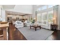 Bright and airy living room with large windows, hardwood floors, and an open layout at 7130 Ansley Park Way, Cumming, GA 30028