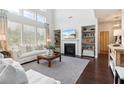 Comfortable living room with built-in bookshelves, fireplace, and lots of natural light at 7130 Ansley Park Way, Cumming, GA 30028